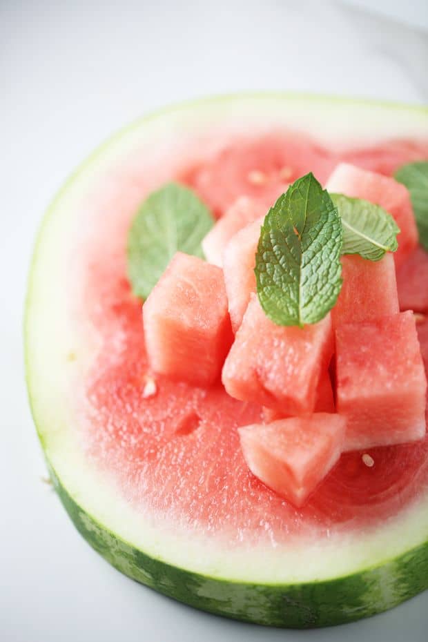 Cubbed watermelon with mint leaves