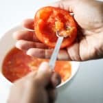 Stuffed tomatoes scooping out