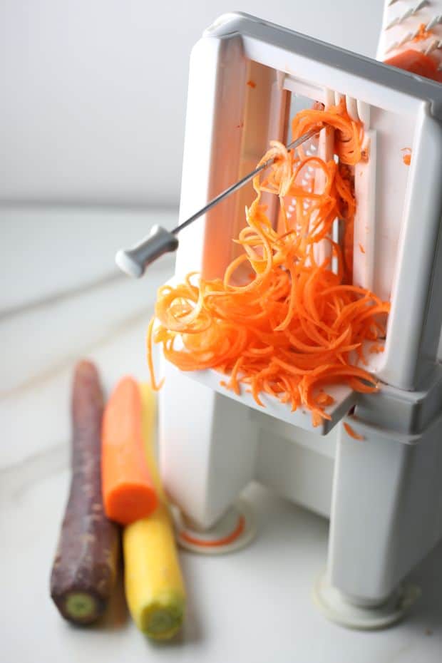 Healthy Multi colored Carrot salad spiralizer in action
