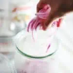 Place red onions into jar