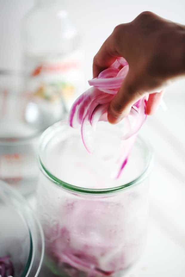 Place red onions into jar