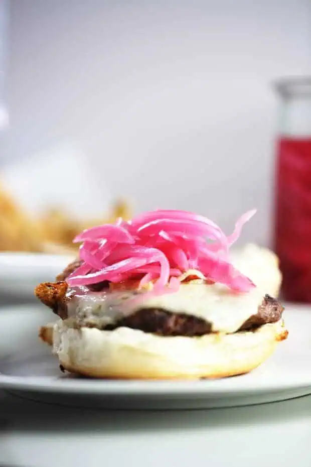 Burger topped with pickled red onions